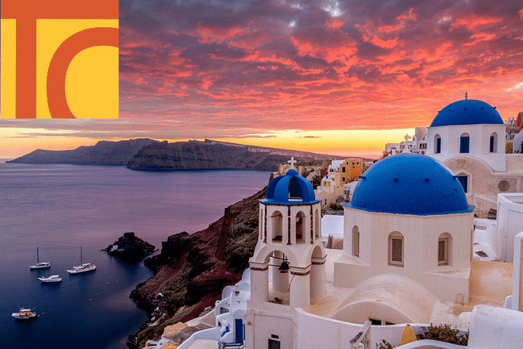 White buildings with blue domes overlook the sea at sunset in Santorini, Greece. Three boats float in the water; a colourful logo appears in the top left corner.