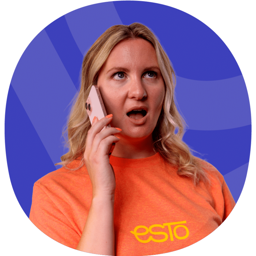 A woman with blonde hair in an orange "ESTO" shirt holds a mobile phone to her ear, looking surprised. The background is blue with abstract shapes.