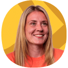 A woman with long blonde hair, wearing an orange top, is smiling in front of a yellow and orange geometric background.