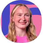 A person with long blonde hair is smiling, wearing a pink top, in front of a background with blue and pink shapes.