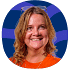 A woman with wavy blonde hair, wearing glasses on her head and an orange shirt, smiling in front of a blue and purple abstract background.