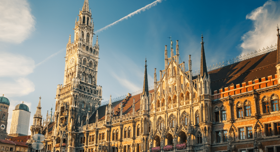 Munich's New Town Hall with its ornate neo-gothic façade and tall clock tower under a clear blue sky.