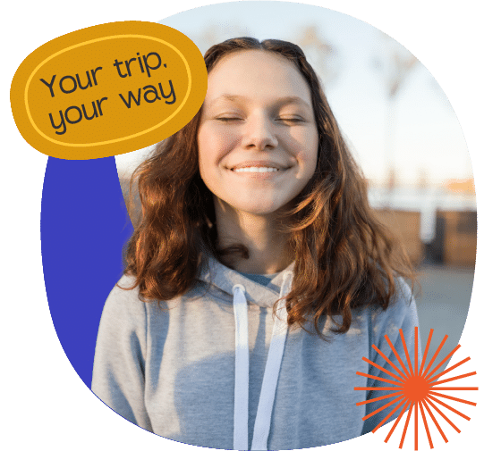 A young woman with brown hair and a grey hoodie smiles with closed eyes outdoors; text reads, "Your trip. your way.
