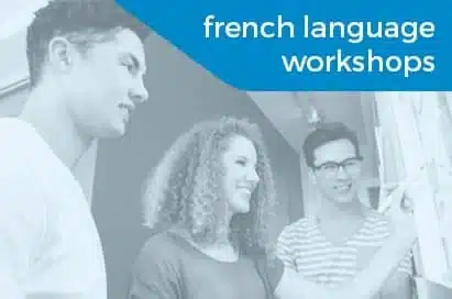 Three people stand together, smiling and writing on a whiteboard. Text reads "French language workshops" in white on a blue background.